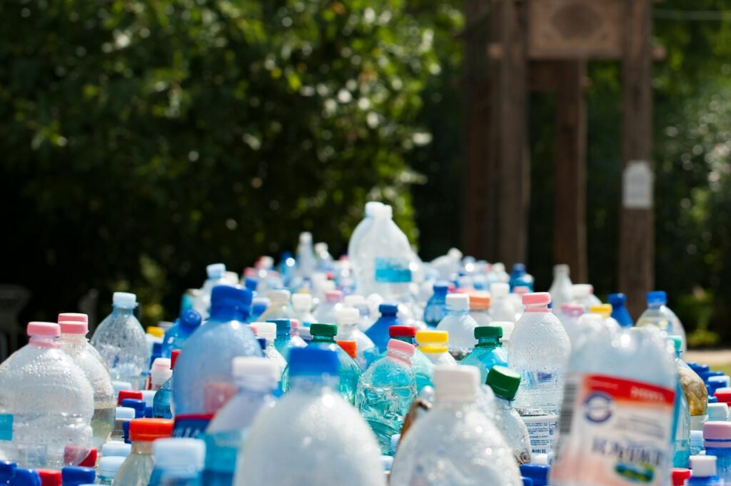 A vibrant collection of plastic bottles in an outdoor recycling setup, showcasing environmental awareness.